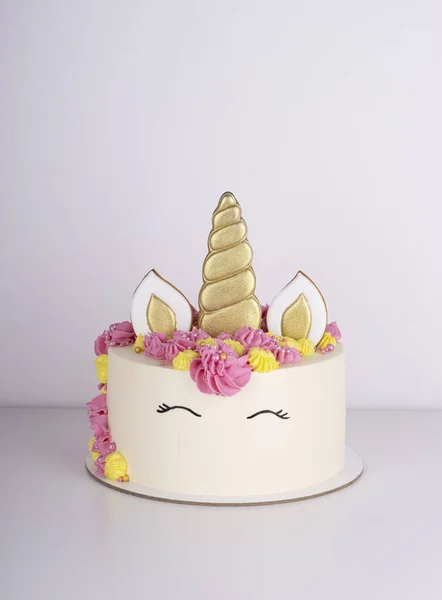 beautiful delicate unicorn birthday cake on a white table