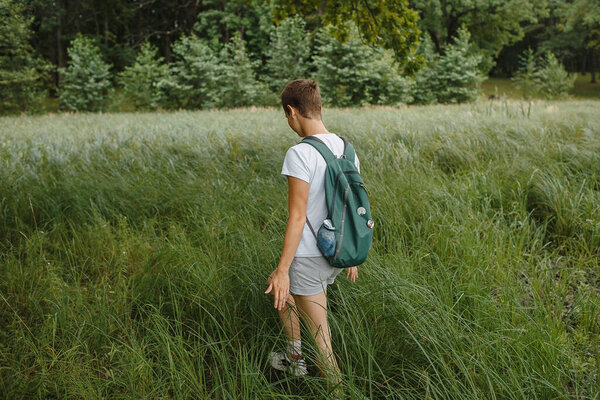 A person in nature, walking in the forest, active recreation