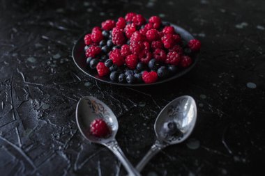 Ahududu ve yabanmersini, siyah arka planda, yabanmersini