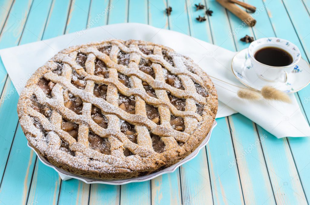 Homemade rustic apple tart pie on dish over wooden turquoise background