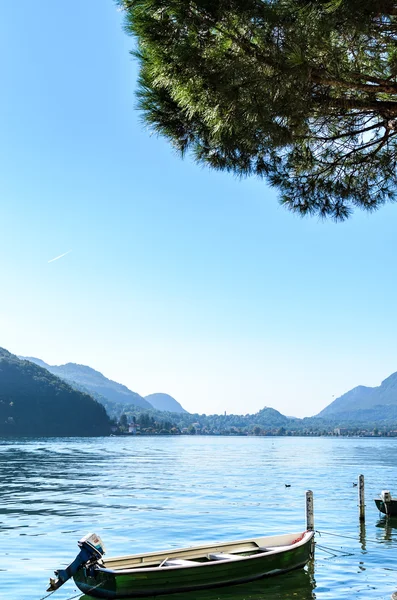 Vacation summer serene Lugano lake surrounded by hills in Morcote, Switzerland