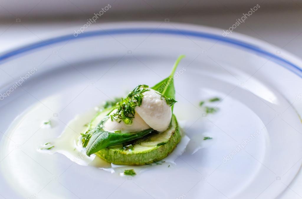 Grilled zucchini with mozzarella, basil and chopped parsley on plate