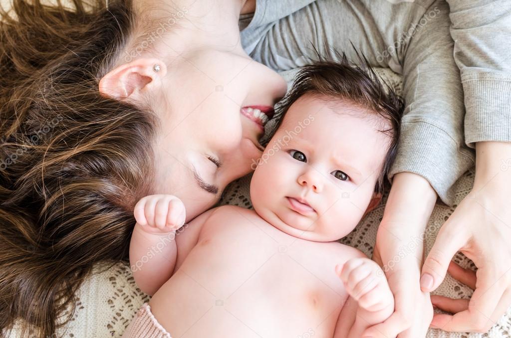 Portrait of happy beautiful mother and cute newborn baby girl