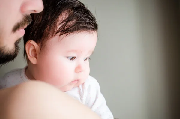 Portrait of happy beautiful little baby girl sitting oh father's hands — Stock Photo, Image