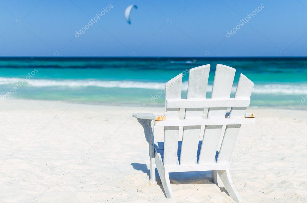 Tropical resort view with beach chair over turquoise sea at exotic sandy beach