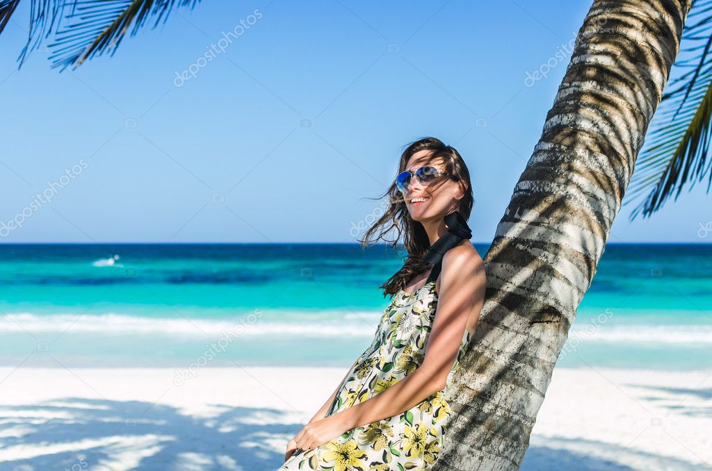 Young adorable woman at tropical sandy beach during Caribbean vacation
