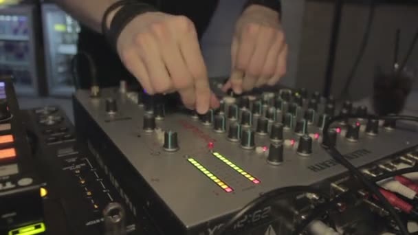 DJ dancing near audio mixer and performing music. Man enjoying his work. Party — Stock Video