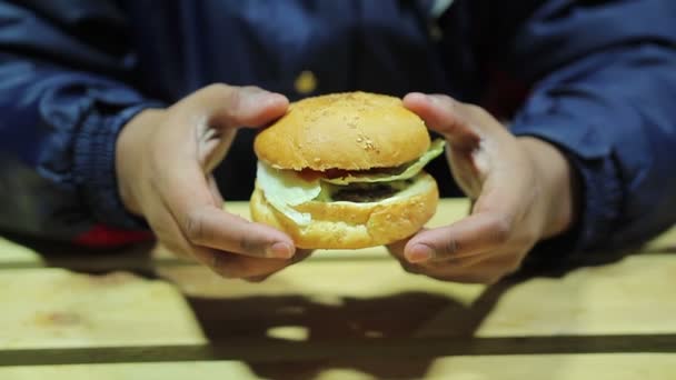 Hungriger Mann erwägt Burger. ungesundes Mittagessen. Fast Food. Cholesterin. Übergewicht — Stockvideo