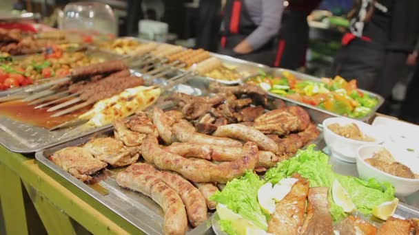 Wide selection of meat dishes at street shop. Fatty unhealthy food, overeating — Stock Video