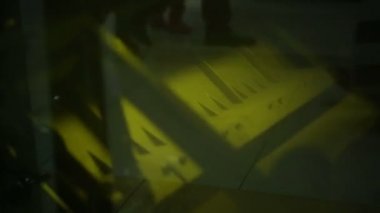Büyük mekanizma hızlı hareket ederken geçen insanların gölgeleri, günlük rutin