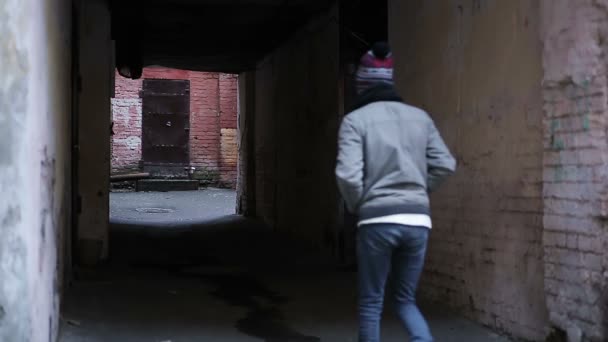 Teenager wandering alone in strange place, depressed young man walking slowly — Stock Video