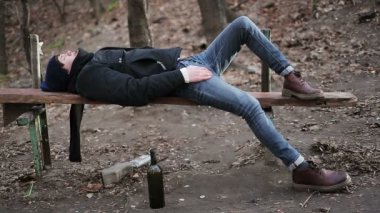 Çok fazla alkol, depresif adam bankta yalan içtikten sonra hasta genç