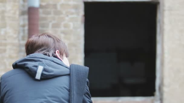 Man sitting alone in empty desolated place, refugee returned home after war — Stock Video