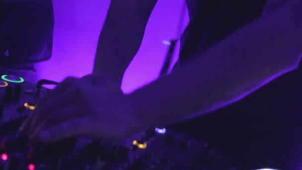 Primer plano de las manos masculinas dj girando los controles en el equipo de sonido en la fiesta del club — Vídeos de Stock