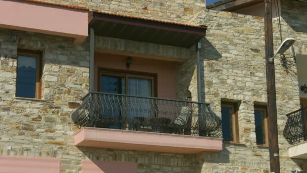 Establishing shot of balcony on private stone house, summertime, sunny weather — Stock Video