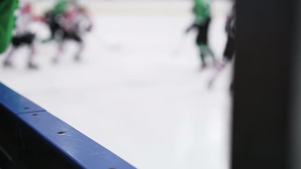 Defocused silhouettes of hockey players and referee during match on ice rink — Stock Video