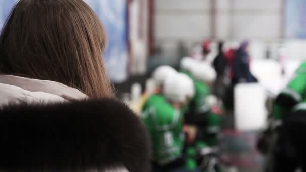 Female fan waiting for favorite hockey player to take autograph after match — Stock Video