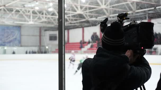 Deportes canal de televisión camarógrafo filmando partido de hockey sobre hielo para el informe, transmisión en vivo — Vídeo de stock