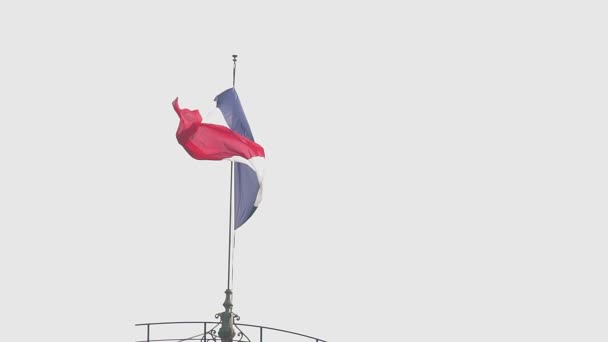 Beautiful French flag hanging on top of building, waving in wind, slow motion — Stock Video