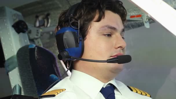 Surprised male pilot rejecting proposal to drink alcohol on board of plane — Stock Video