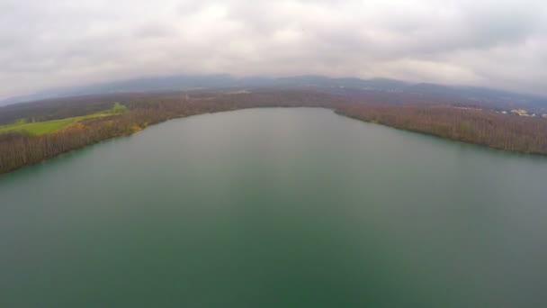 Plano aéreo del paisaje otoñal, amplio río tranquilo, nubes grises en el cielo en el horizonte — Vídeos de Stock