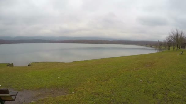 Timelapse of lonely bench at lakeside, birds swimming, depression, sad memories — Stock Video