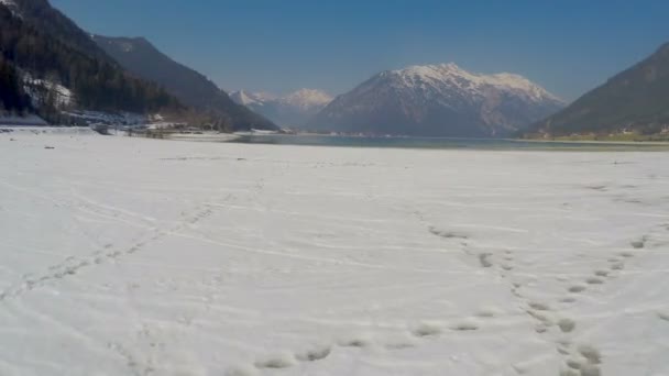 Low water level in lake, empty boat dock, off-season Austrian Alps ski resort — Stock Video