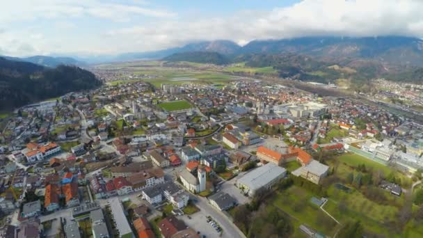 Воздушная панорама современного города в зеленой альпийской долине, красивая горная природа — стоковое видео