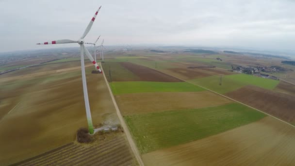 Aerial view of wind turbines with huge rotating blades. Green energy production — Stock Video