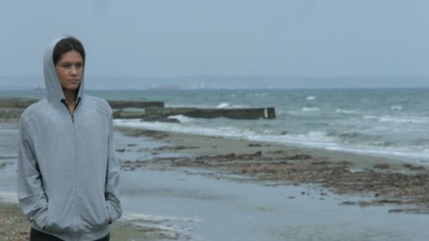 Beautiful young female feeling upset, looking at gloomy seascape, thinking — Stock Video