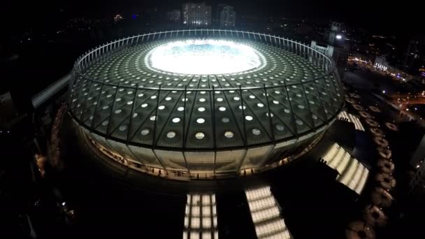 KYIV, UCRANIA - CIRCA JUNIO 2016: Vista aérea del estadio Olimpiyskiy. Tribunes del estadio llenos de aficionados al fútbol, plano aéreo nocturno de la arena moderna — Vídeos de Stock