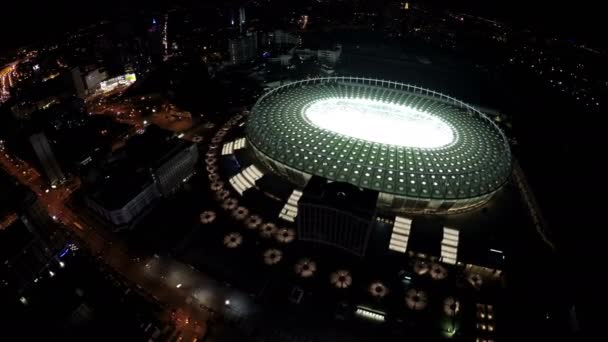 KYIV, UCRANIA - CIRCA JUNIO 2016: Vista aérea del estadio Olimpiyskiy. Estadio de fútbol iluminado de forma ovalada, vista aérea en la hermosa ciudad nocturna — Vídeos de Stock