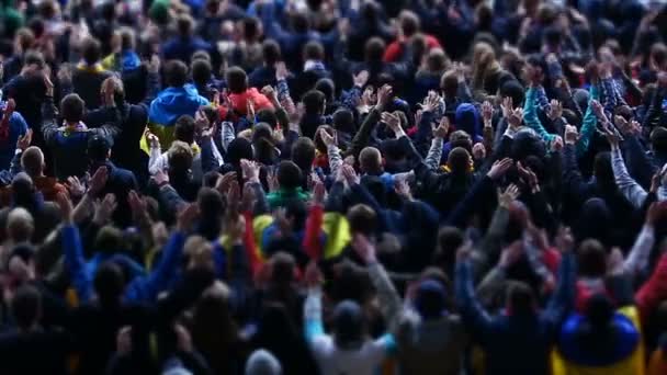 Football fans actively applauding and waving hands at stadium during match — Stock Video