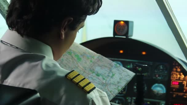 Male co-pilot checking map before operating airliner, responsibility, commitment — Stock Video