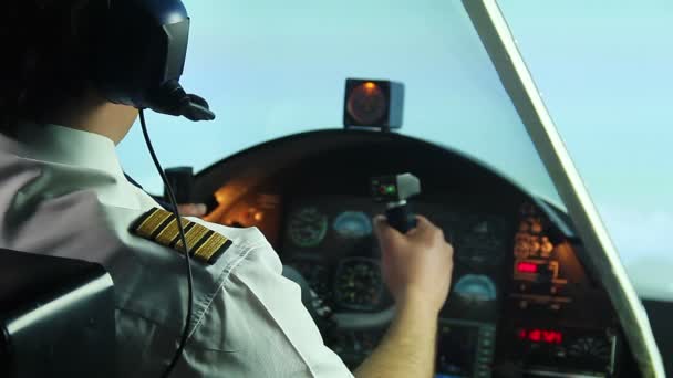 Confident male pilot operating airplane and refusing alcoholic drink in cockpit — Stock Video