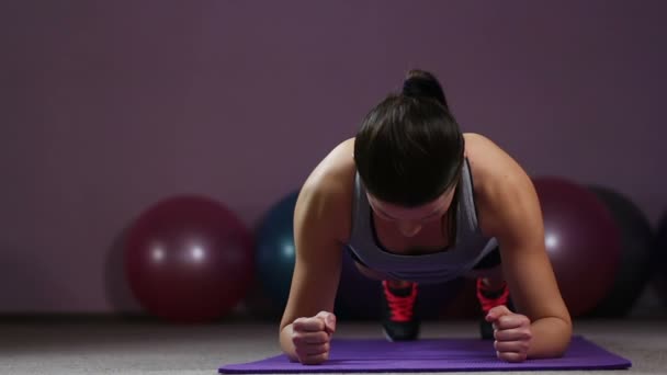 Sportive woman performing plank, finishes exercising in gym, healthy lifestyle — Stock Video