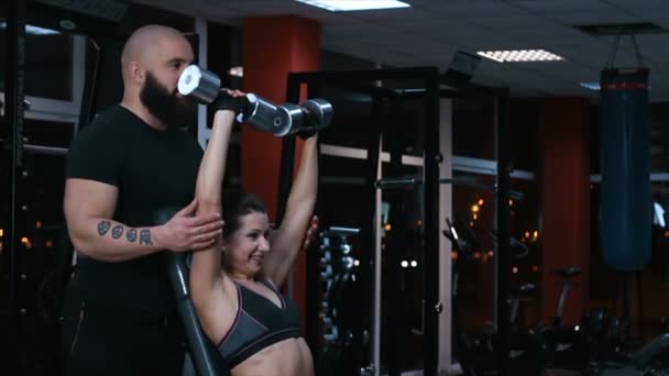 Personal coach training female athlete, instructing woman on dumbbell exercises — Stock Video