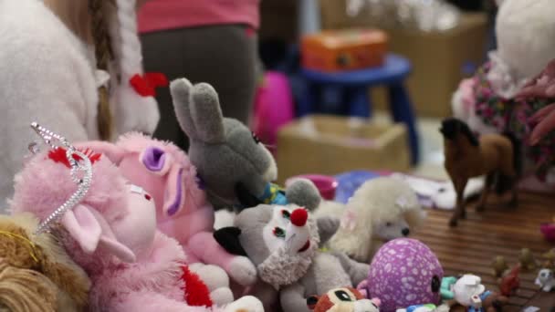 People selling soft toys at charity garage sale, raising funds to help children — Stock Video