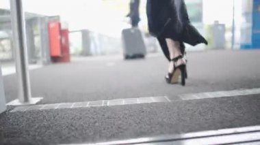Topuklar ve adam asansörden, Çift seyahat bavul ile şık kadın