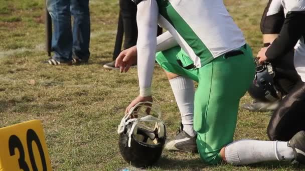 Male football players ready to play, watching match, waiting for substitution — Stock Video