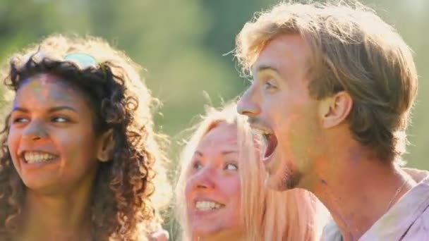 Happy male and female students joking, laughing and having fun at color festival Stock Footage