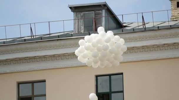 Un mucchio di palloncini bianchi che volano nel cielo blu, cerimonia tradizionale, ambiente — Video Stock