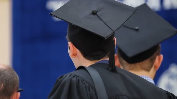 Excited male student waiting for his turn to receive higher education diploma — Stock Video