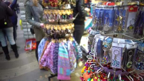 Variety of colorful token gifts at souvenir shop for tourists to remember trip — Stock Video