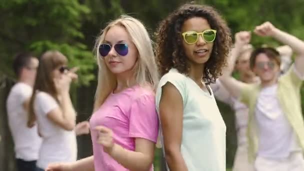 Hermosas chicas sacudiendo cuerpos sexy, bailando con música en la fiesta de verano al aire libre — Vídeo de stock