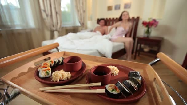 Wife bringing Japanese sushi to husband — Stock Video