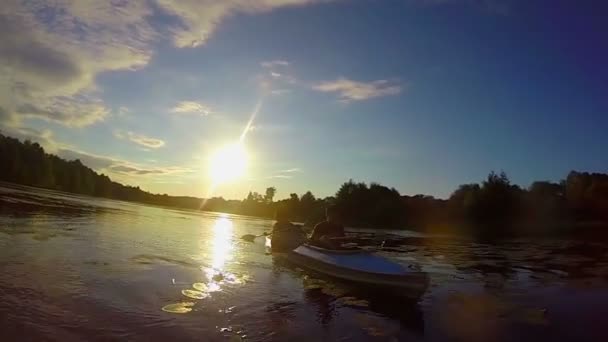 Turisté, pádlování kajak při západu slunce — Stock video