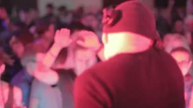 Erkek disk jokey gece kulübünde set oynarken, kalabalık müzik zevk