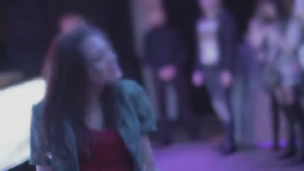 Girl dancing in euphoria, many people moving wildly to music — Stock Video