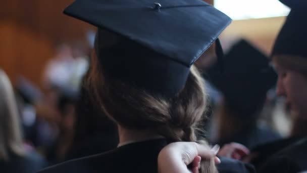 Madre intreccia i capelli della figlia. Preparativi per la cerimonia di laurea al college — Video Stock